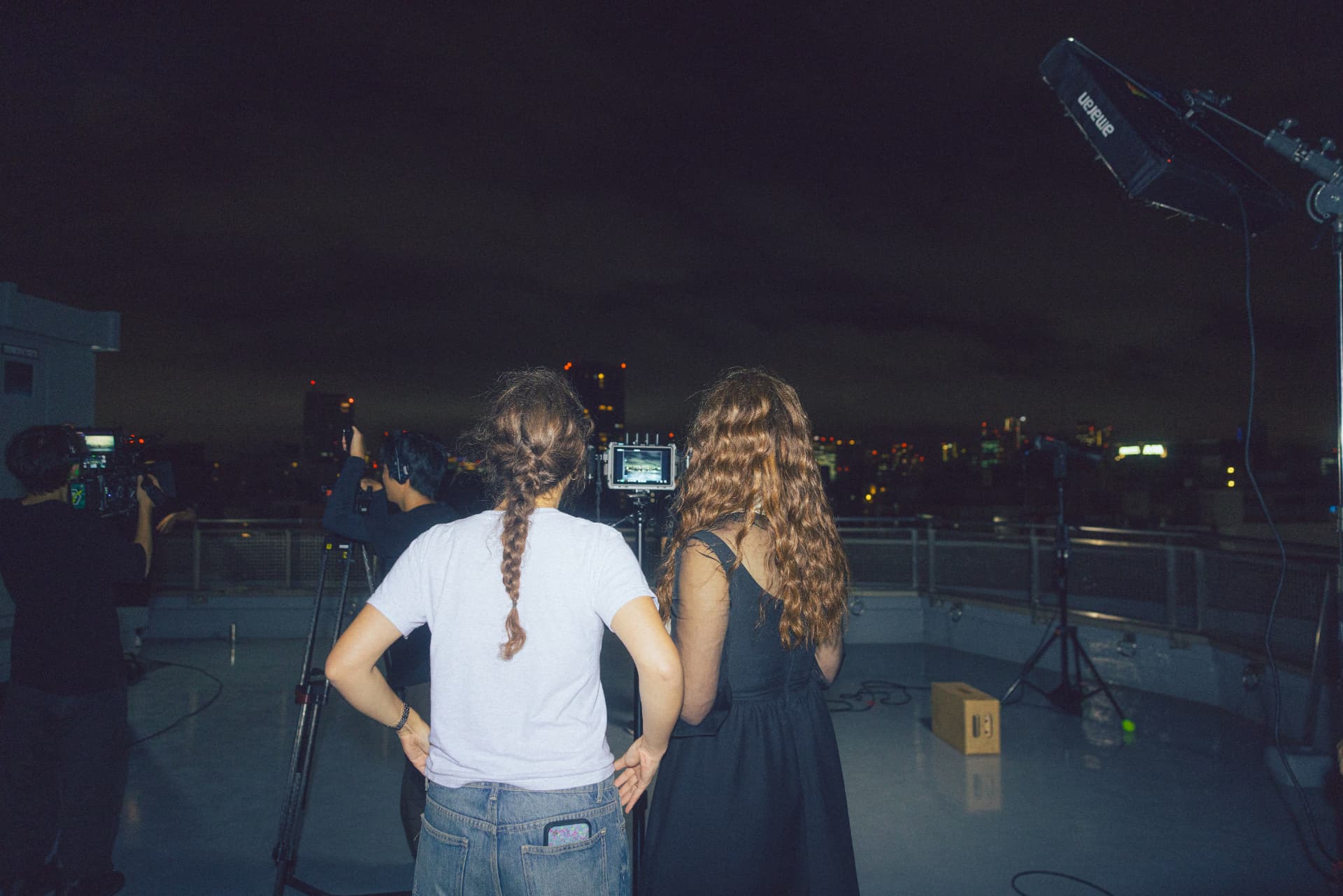 Laufey and the production crew reviewing a rooftop shot